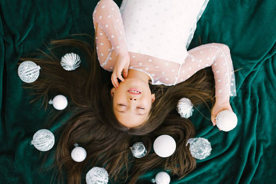 Portrait of cute girl sitting on bed