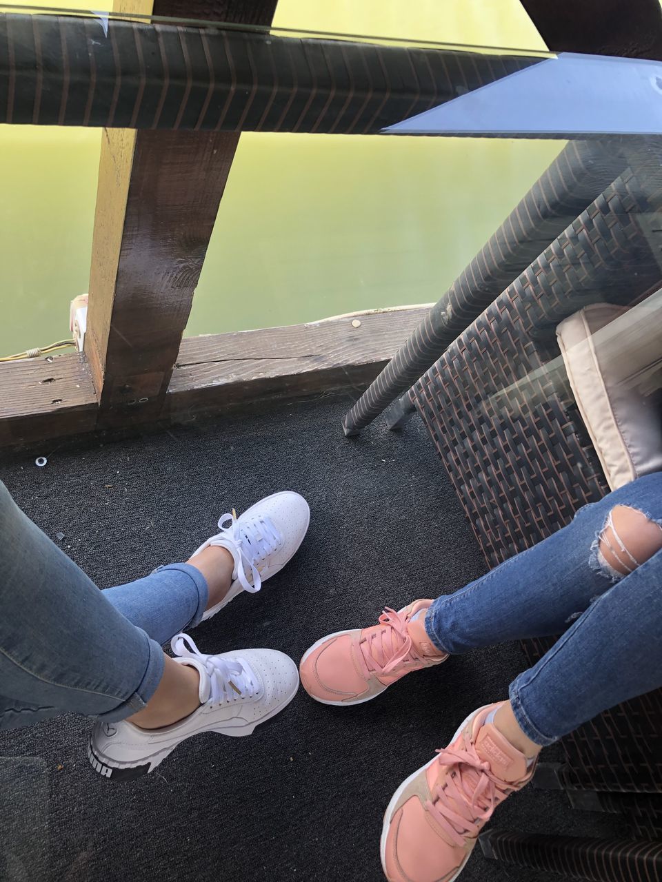 low section, human leg, adult, blue, shoe, lifestyles, women, limb, casual clothing, footwear, yellow, jeans, high angle view, human limb, clothing, leisure activity, men, two people, togetherness, personal perspective, architecture, day, standing, city, outdoors, young adult, friendship