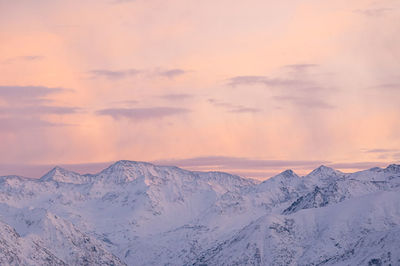 Scenic view of snowcapped mountains against sky during sunset