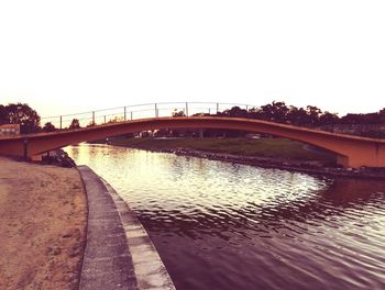 Bridge over river against clear sky