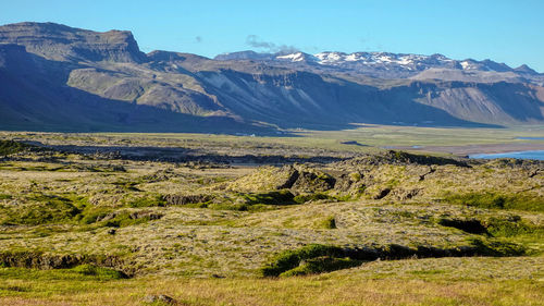 Scenic view of landscape and mountains against sky at raudfeldsgja gorge