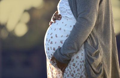 Midsection of woman standing at home