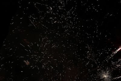 Low angle view of illuminated lights at night