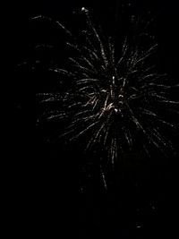 Low angle view of firework display at night