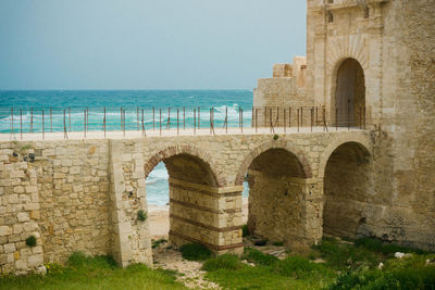 View of historical building against sea