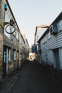 Street amidst buildings against clear sky