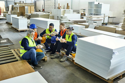 Workers in factory having lunch break together