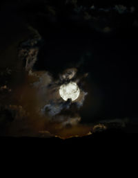 Low angle view of silhouette moon against sky at night
