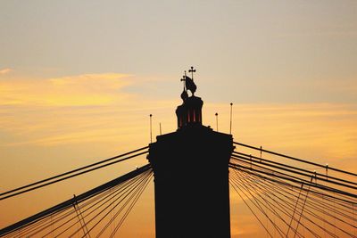 Low angle view of silhouette statue against sky during sunset