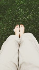 Low section of woman standing on grass