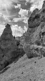 Rock formations on landscape against sky