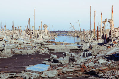 Demolished buildings against clear sky during hurricane harvey