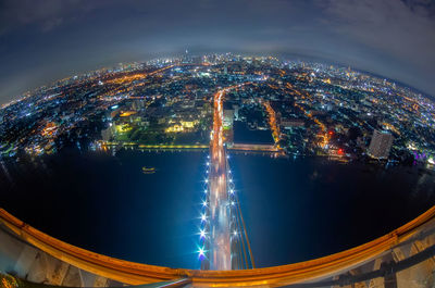 High angle view of illuminated city buildings at night