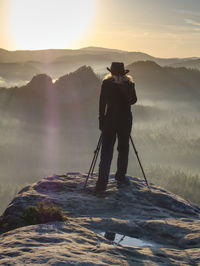 Woman nature art photographer works. takes photo and walking in nature. travel relax and nature 