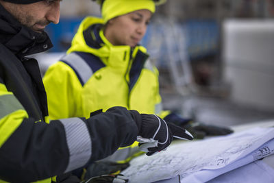 Construction engineers discussing project at construction site