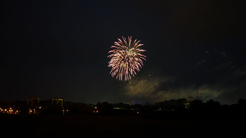 Low angle view of firework display at night