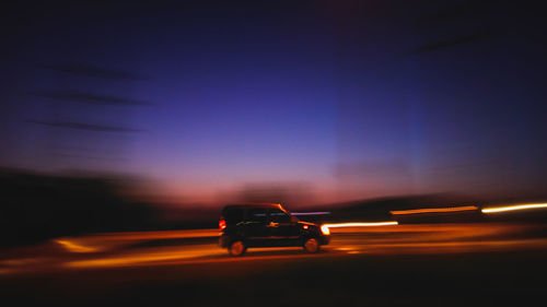 Blurred motion of car on road at night