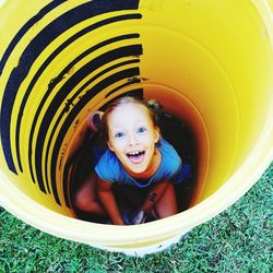 High angle portrait of girl sitting in drum