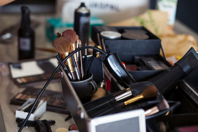 Dedicated focus make-up converter on makeup artist's table with lots of makeup artist tools.