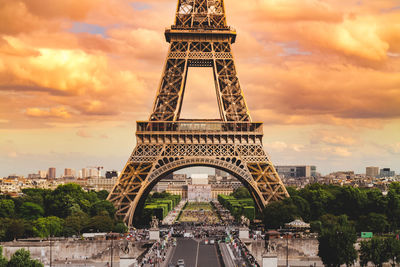 View of eiffel tower in city against cloudy sky