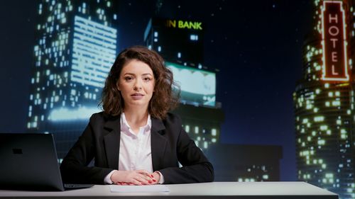 Portrait of young businesswoman using mobile phone in office