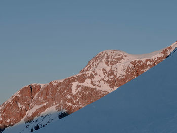 Scenic view of snowcapped mountains against clear blue sky