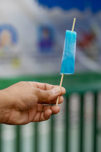 Cropped hand holding ice cream