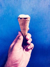Close-up of hand holding ice cream