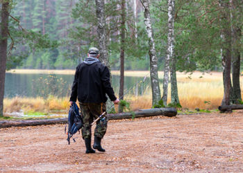 Rear view of man standing in forest