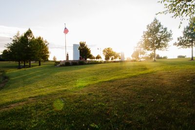 Scenic view of grassy field against sky