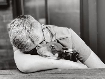 Man with dog relaxing at home