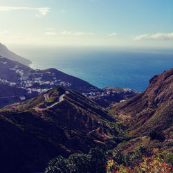 High angle view of sea and mountains against sky