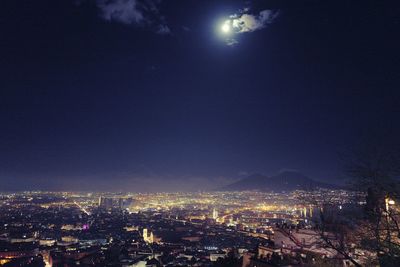 High angle view of illuminated city against clear sky at night