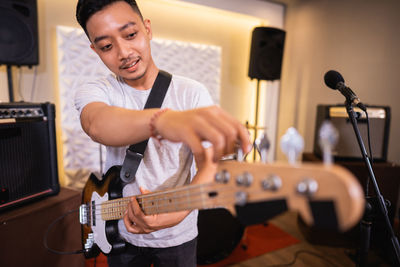 Portrait of man playing guitar