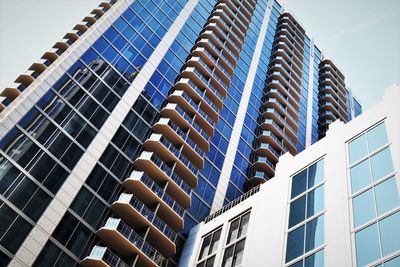 Low angle view of modern buildings against sky in city