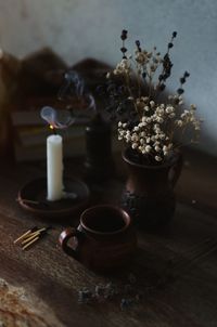 High angle view of candle and flowers on table