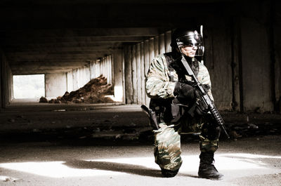 Army soldier with gun in tunnel