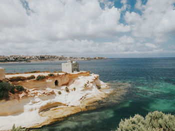 Scenic view of sea against cloudy sky