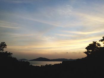 Scenic view of silhouette mountains against sky at sunset