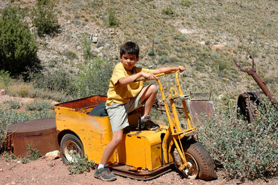 Portrait of boy sitting on vehicle