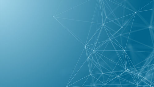 Low angle view of illuminated blue sky