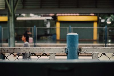 Close-up of railing by railroad track