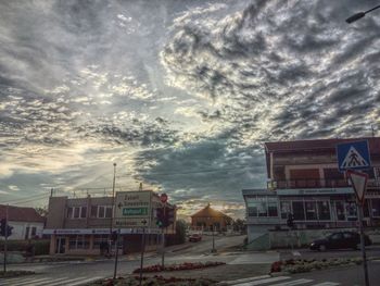 View of residential buildings against cloudy sky