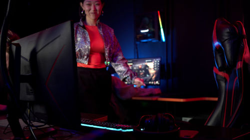 Smiling woman standing in internet cafe