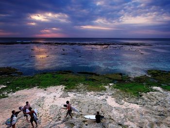 People on beach against sky