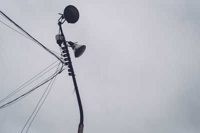 Low angle view of cables against sky