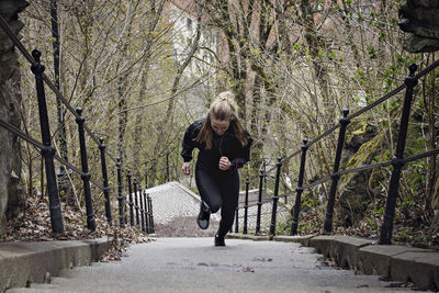 Full length of fit woman moving up stairs