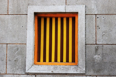 Close-up of yellow window on building