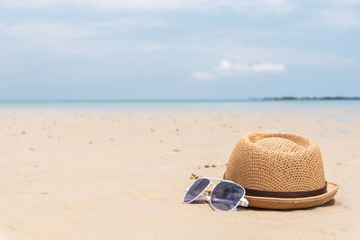 View of hat on beach against sky