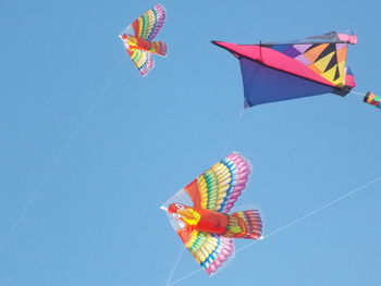 Low angle view of flag against clear blue sky